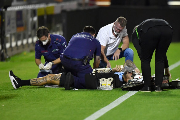 Andrew Fifita being treated on the side of the pitch at Redcliffe Stadium on Sunday night.