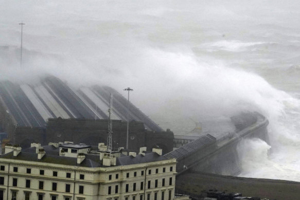 Waves crash over the harbour wall as Storm Ciaran brings high winds and heavy rain along the south coast of England.
