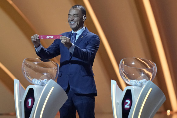 Former Brazilian soccer international Cafu holds up the name of Qatar at the World Cup draw.