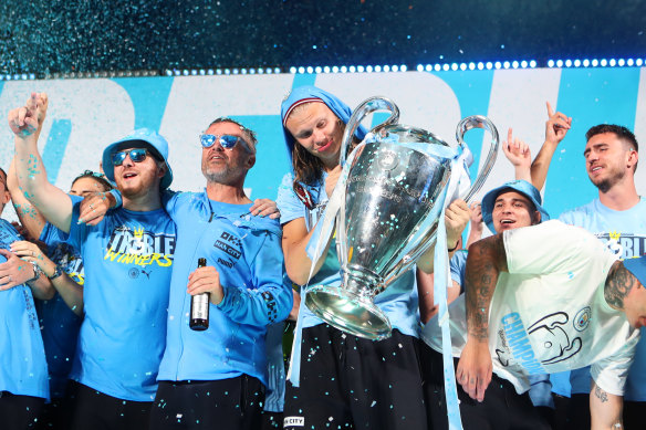 Erling Haaland celebrates with the UEFA Champions League trophy.