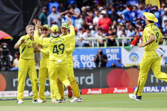 An ecstatic Australian side after claiming the wicket of Virat Kohli.