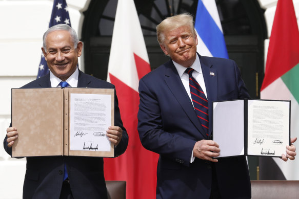 Israeli Prime Minister Benjamin Netanyahu and US President Donald Trump hold the signed documents at the White House.