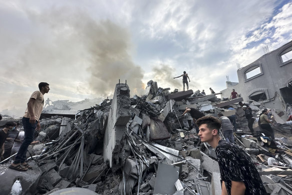 Palestinians look for survivors after an Israeli airstrike on Nusseirat refugee camp.