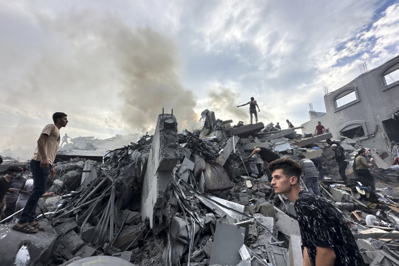 Palestinians look for survivors after an Israeli airstrike in Nusseirat refugee camp on October 31.