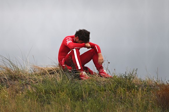 Charles Leclerc watches the race after retiring his Ferrari.