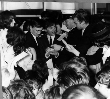 Gerry Marsden, (centre), is surrounded by fans during a personal appearance at the Southern Cross Hotel, Melbourne, to aid the Miss Teenage Quest and the Royal Hospital, in 1964.