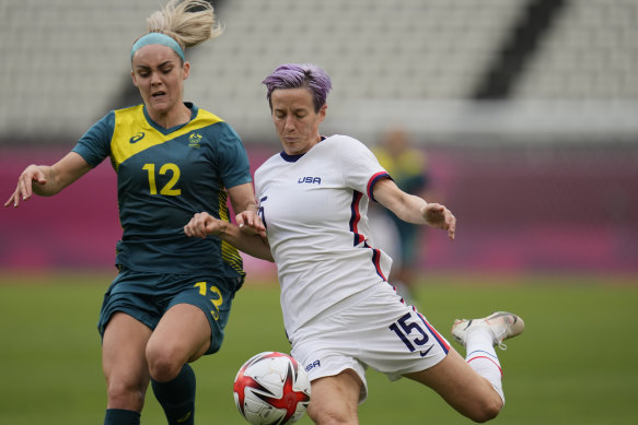 Australia’s Ellie Carpenter and USA superstar Megan Rapinoe battle for the ball at the Tokyo Olympics.