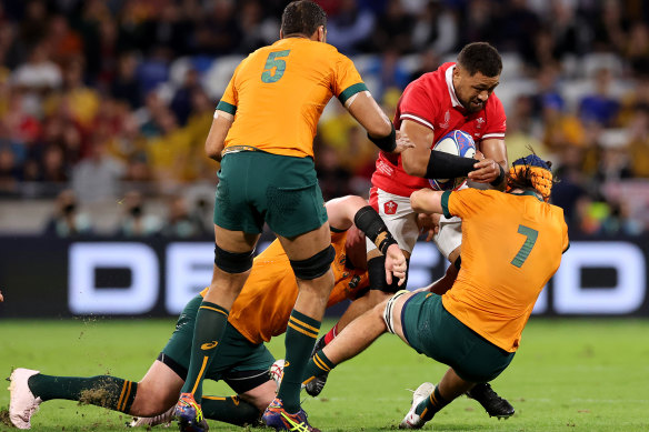 Taulupe Faletau is tackled by Tom Hooper.