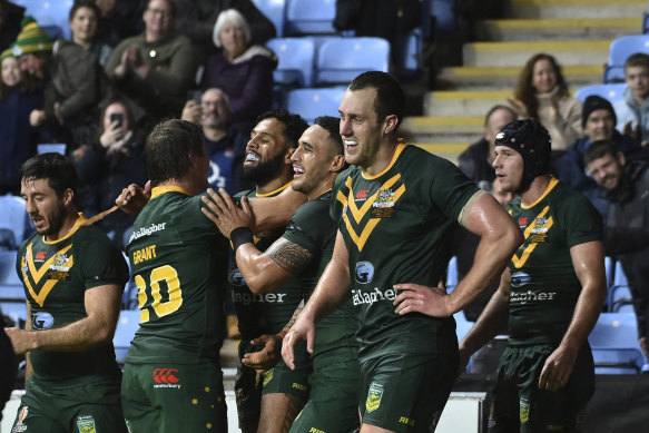 Australia’s Josh Addo-Carr, centre, celebrates with teammates after scoring the winning try during the Rugby League World Cup match between Australia and Scotland.
