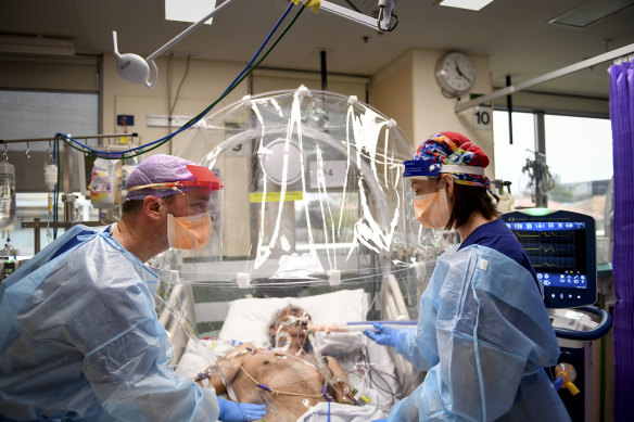 Medical workers treat a COVID-19 patient at Footscray Hospital in Melbourne in July 2020.