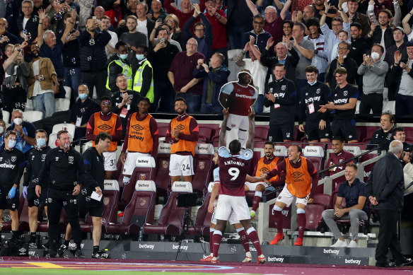 Michail Antonio celebrates with a cardboard cutout of himself at the London Stadium.