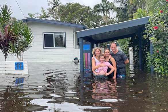 The Jones-Lawson family visit their home during the 2022 flood.