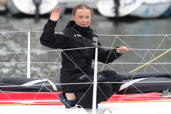 Greta Thunberg waves to her supporters on her arrival in New York aboard the zero-emissions yacht Malizia II on Wednesday. 