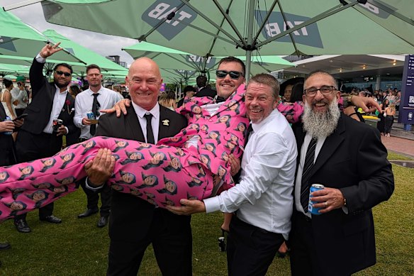 Paul Whitehand, Scott Parsons and Ken Pace lift groom-to-be Josh Parsons as part of big bucks party celebrations on Derby Day.