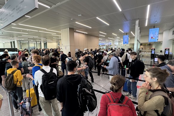 Passengers wait in long queues at passport control in the departures terminal of Brussels Airport.