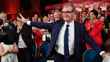 NSW Labor leader Michael Daley waves to the crowd as he leaves the NSW Labor Party election campaign launch in Revesby on Sunday. 