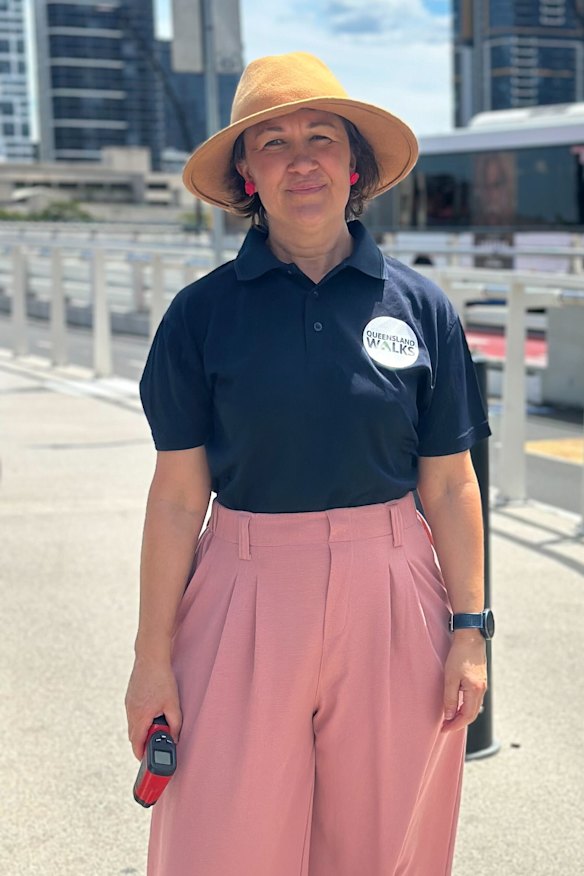 Anna Campbell from Queensland Walks tests the temperature on Victoria Bridge with an infrared thermometer gun.