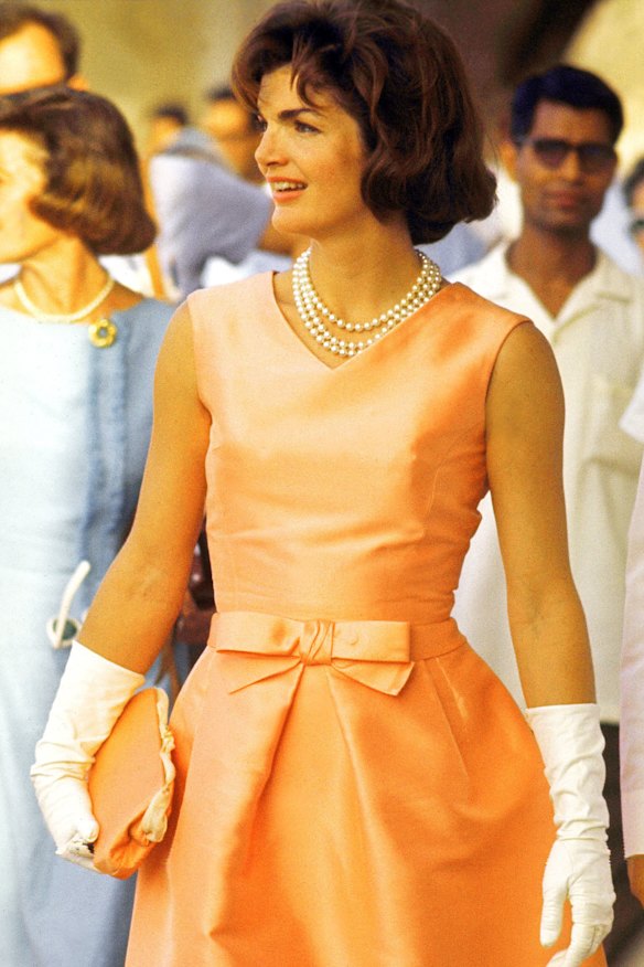 Jackie Kennedy wearing a triple strand of pearls on a visit to India.