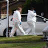 Police at the house in Rosemeadow, where three people died in an attack on Sunday morning.
