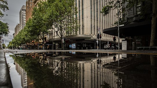 An empty Swanston Street was wet - and empty - all weekend.
