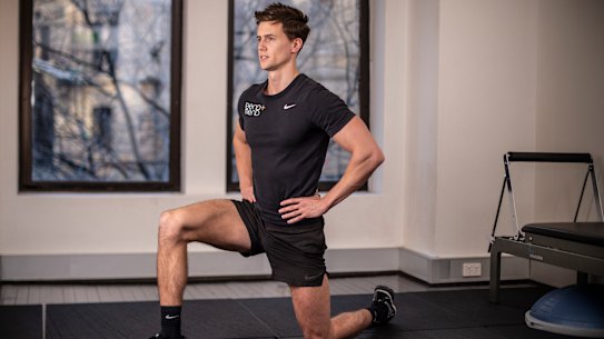 Physiotherapist Ben Wright does a hip flexor stretch.