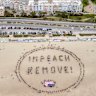 Protesters form an “Impeach & Remove” human banner on Ocean Beach in San Francisco.