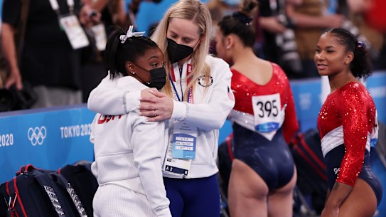 Simone Biles is comforted by coach Cecile Landi.
