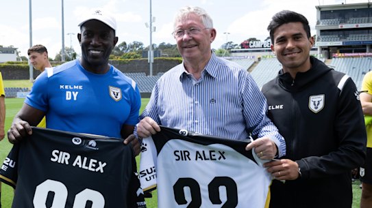 Sir Alex Ferguson visits Macarthur FC, coached by Dwight Yorke (left), and with captain Ulises Davila (right).