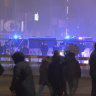 A group of pro-Palestine protesters walk towards a police line near the soccer stadium in Amsterdam, the Netherlands.
