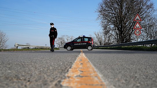 A sole Carabinieri officer at a checkpoint near Codogno, one of dozens of similar roadblocks set up in northern Italy. 