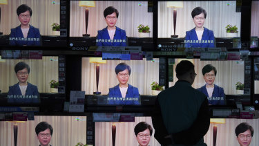 A man watches the television message of Carrie Lam announcing the withdrawal of the extradition bill.