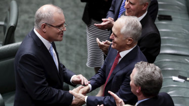 Treasurer Scott Morrison is congratulated by Prime Minister Malcolm Turnbull after delivering the budget speech.