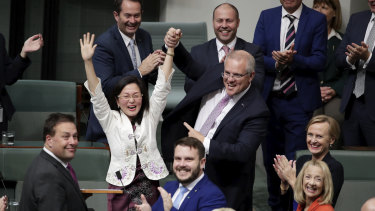 Liberal MP Gladys Liu is congratulated by Prime Minister Scott Morrison  after delivering her first speech in the House of Representatives in July 2019.