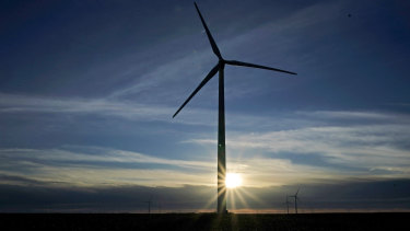 A wind turbine is silhouetted against the rising sun near Spearville, Kansas, one of the states suing US President Joe Biden over one of his first executive orders.