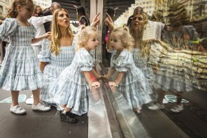 Window on tradition: Lorinska Merrington and daughters Penelope, 5, and Florence, 2, on the first day of the 2021 Myer Christmas Windows in Bourke Street Mall. 
