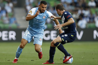 Andrew Nabbout of Melbourne City  tries to evade Victory’s Leigh Broxham.