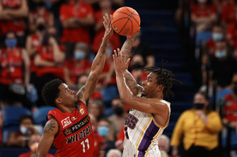 Sydney import Jaylen Adams drives to the hoop against Perth guard Bryce Cotton.