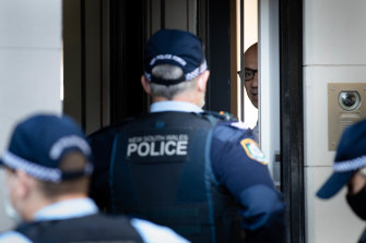 Moses Obeid talks to police at his Paddington home on Thursday afternoon.