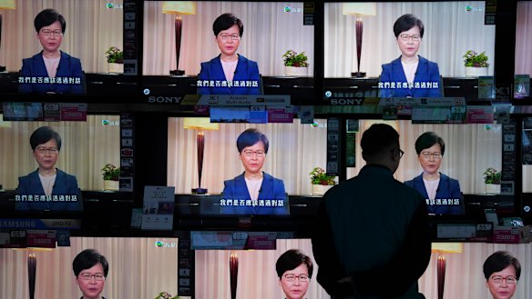 A man watches the television message of Carrie Lam announcing the withdrawal of the extradition bill.