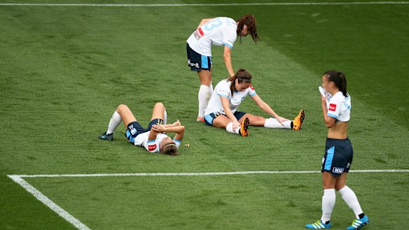 Distraught:  Sydney FC slump to the ground at the sound of the final whistle. 