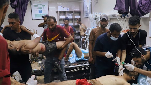 Palestinians injured while trying to reach aid trucks entering Gaza Strip  receive treatment on Tuesday.