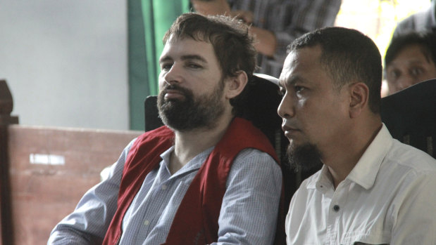 French national Felix Dorfin, left, is accompanied by an interpreter during his sentencing hearing.