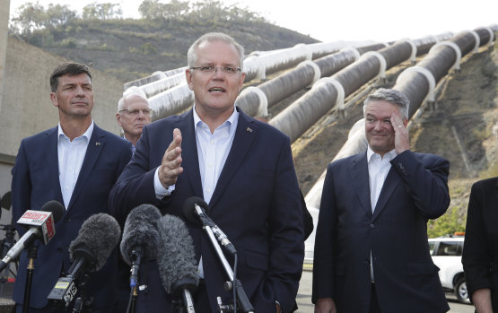 Minister for Energy Angus Taylor, Prime Minister Scott Morrison and Minister for Finance and the Public Service Mathias Cormann speak to the media during a visit to the Snowy Hydro Tumut 3 power station in Talbingo, NSW. 