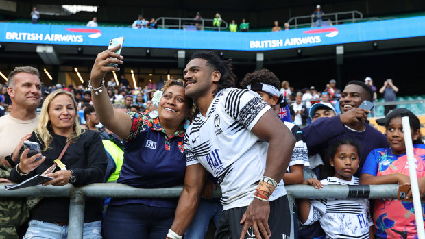 Fiji’s Selestino Ravutaumada poses with fans after the England win.