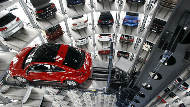 A New Beetle car is lifted inside a delivery tower after the company's annual press conference in Wolfsburg, Germany, in 2002.
