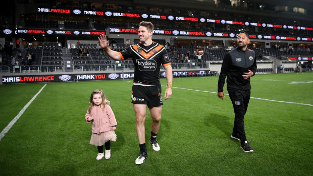Benji Marshall takes a farewell lap with Chris Lawrence and his daughter.