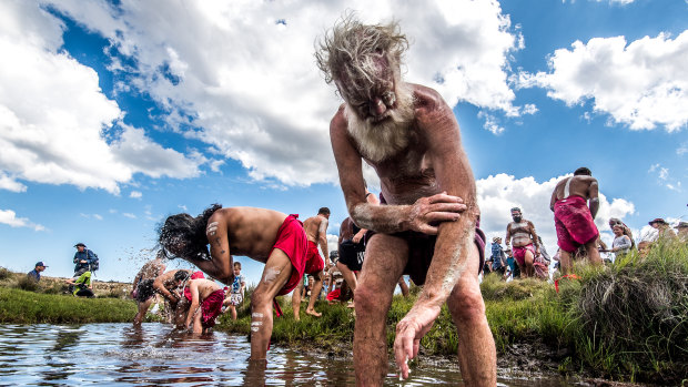 Author Bruce Pascoe (foreground) and other participants in the ceremony wash ochre from their bodies in the Murrumbidgee River.