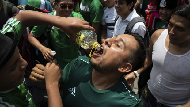 Jubilant fans share tequila in Mexico City.