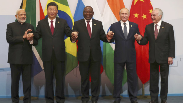 Members of the major emerging national economies group BRICS, with from left, Indian Prime Minister Narendra Modi, China's President Xi Jinping, South African President Cyril Ramaphosa, Russia's President Vladimir Putin, and Brazil's President Michel Temer.