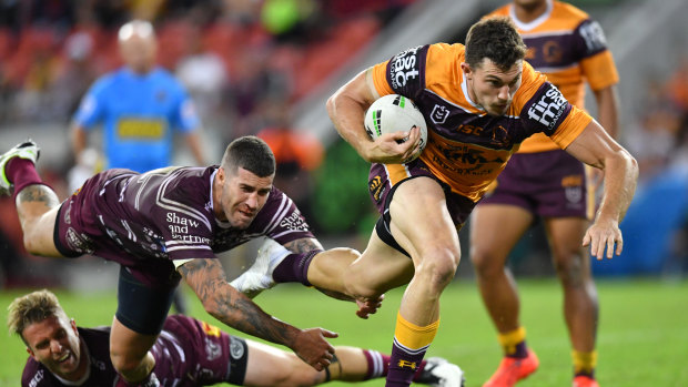 Galloping Bronco: Winger Corey Oates evades the clutches of Manly's Joel Thompson on Friday night.